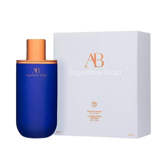 Augustinus Bader The Eye Cream — cobalt blue jar with copper-toned lid, displayed on a white surface.