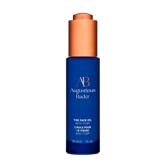Augustinus Bader The Face Oil — cobalt blue bottle with copper dropper, shown upright on a clean white background.
