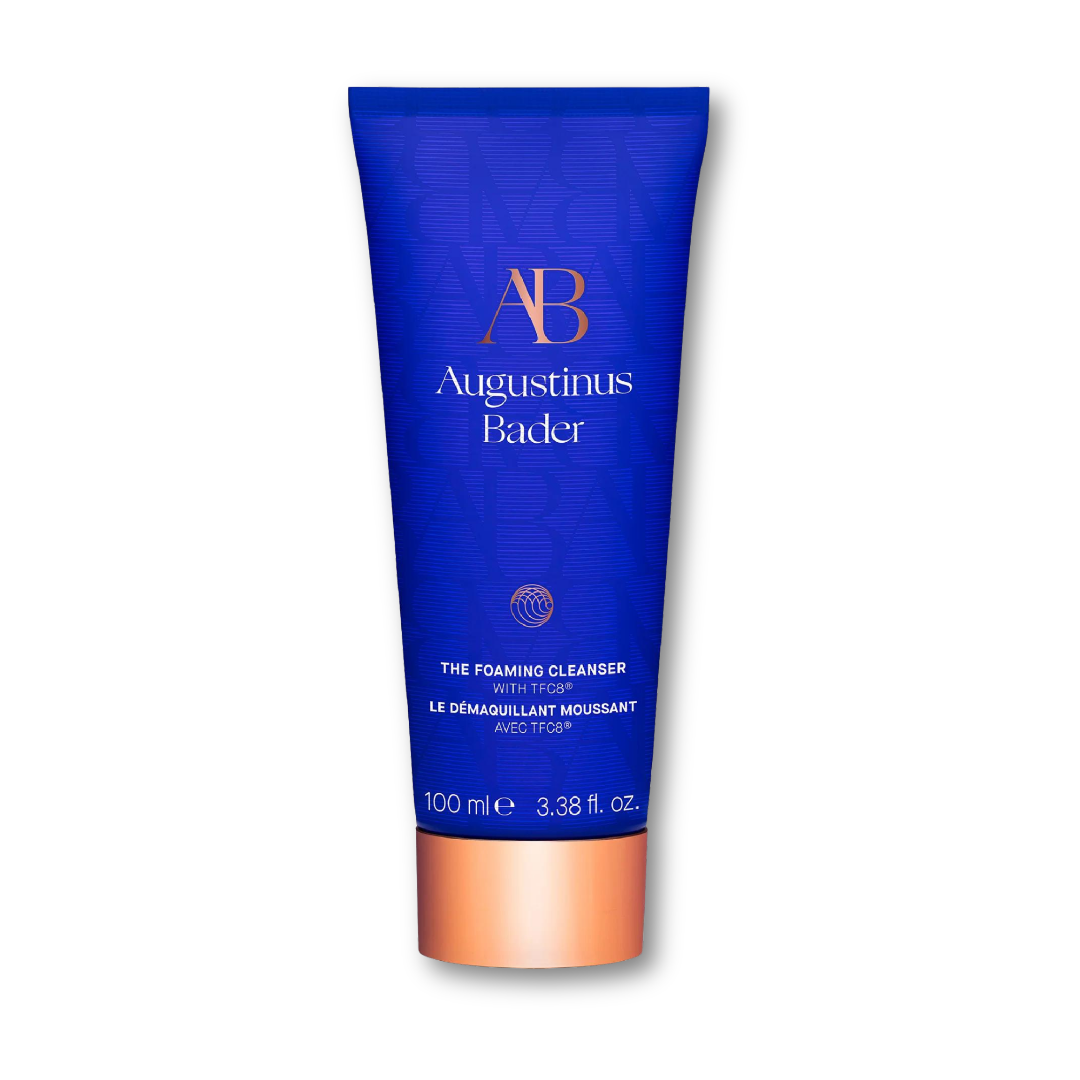 Augustinus Bader The Foaming Cleanser — cobalt blue pump bottle with copper detail, shown upright on a white background.